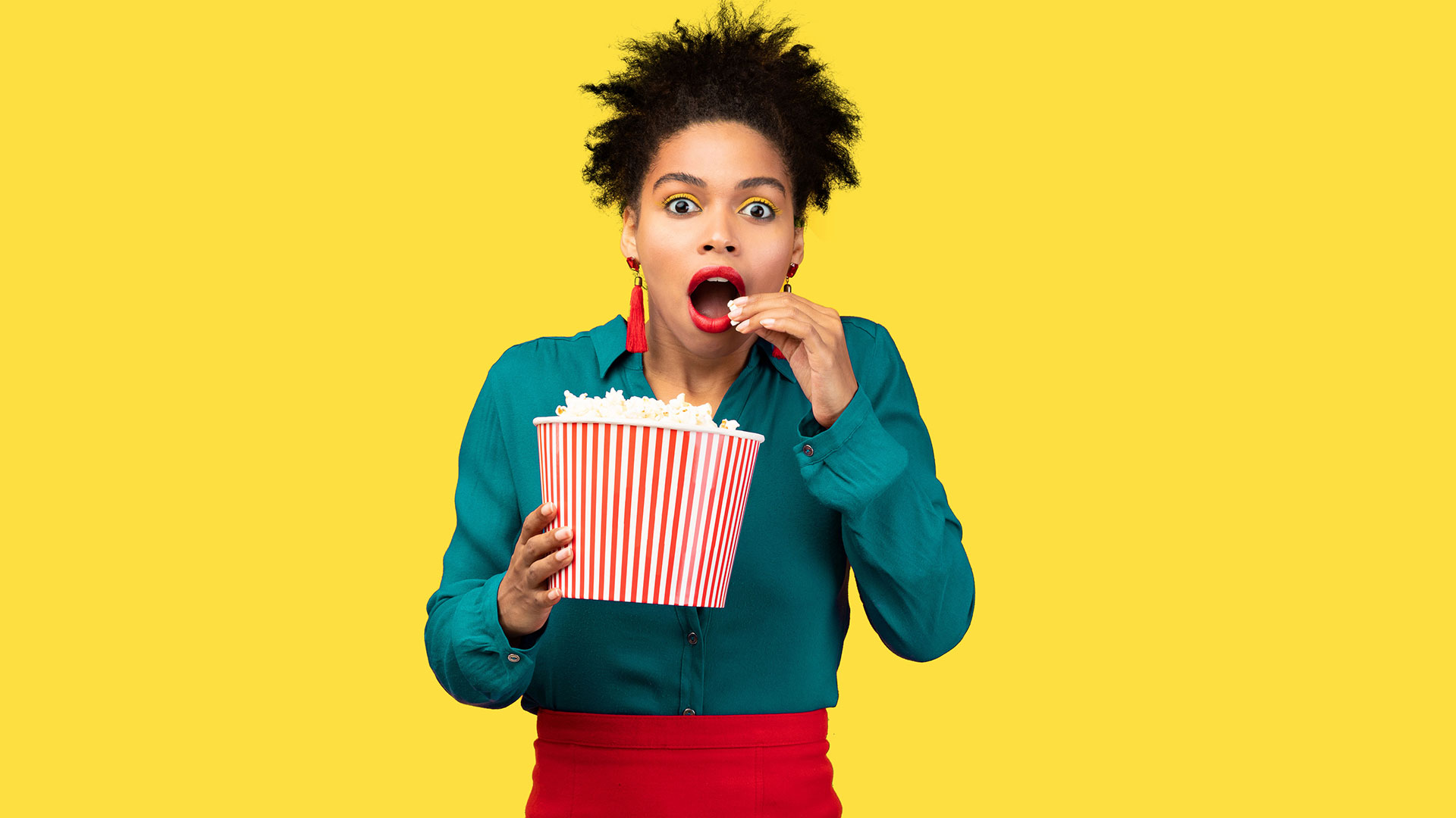 woman eating popcorn popped in canola oil